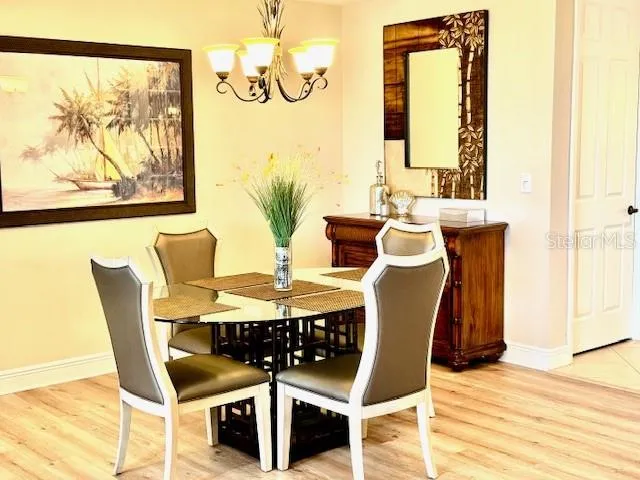 a view of a dining room with furniture and wooden floor