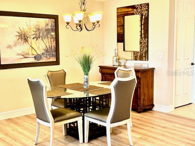 24417 Baltic Avenue, Unit 1102 Punta Gorda, FL 33955 - Photo 18 of 53 a view of a dining room with furniture and wooden floor