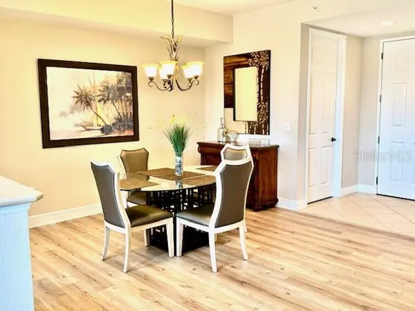 a view of a dining room with furniture and chandelier