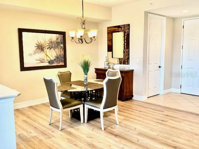 a view of a dining room with furniture and chandelier