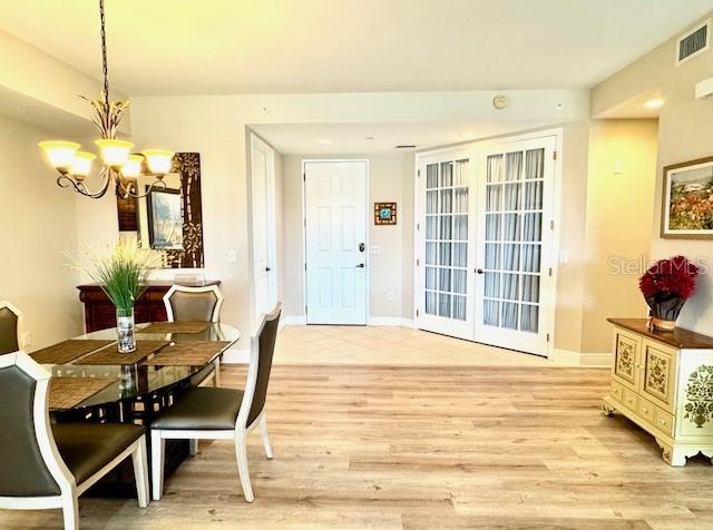 24417 Baltic Avenue, Unit 1102 Punta Gorda, FL 33955 - Photo 20 of 53 a view of a dining room with furniture and chandelier