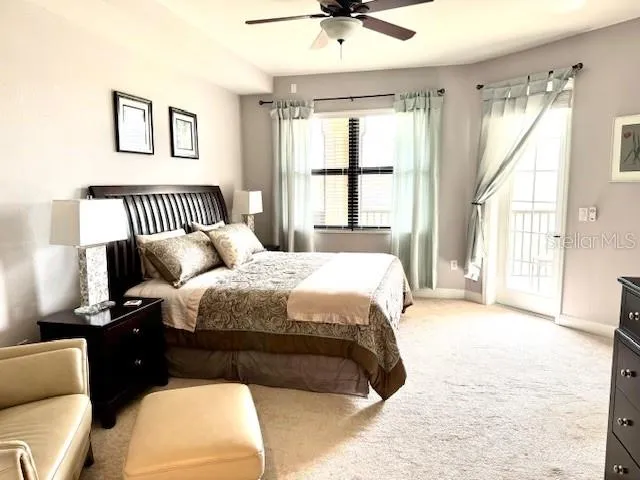 a bedroom with a large bed and a couch