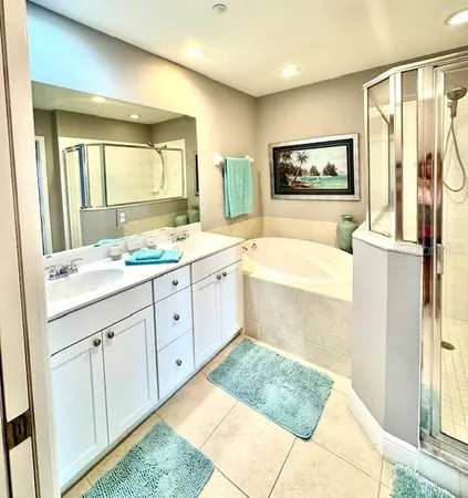 a bedroom with a bed painting on wall and a large window