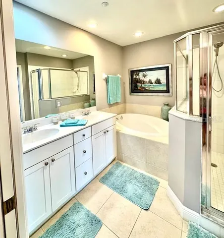 a bedroom with a bed painting on wall and a large window