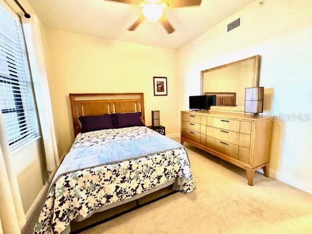 24417 Baltic Avenue, Unit 1102 Punta Gorda, FL 33955 - Photo 26 of 53 a bedroom with a bed dresser and a flat tv screen