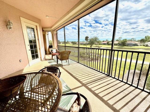 24417 Baltic Avenue, Unit 1102 Punta Gorda, FL 33955 - Photo 4 of 53 a view of a balcony with wooden floor