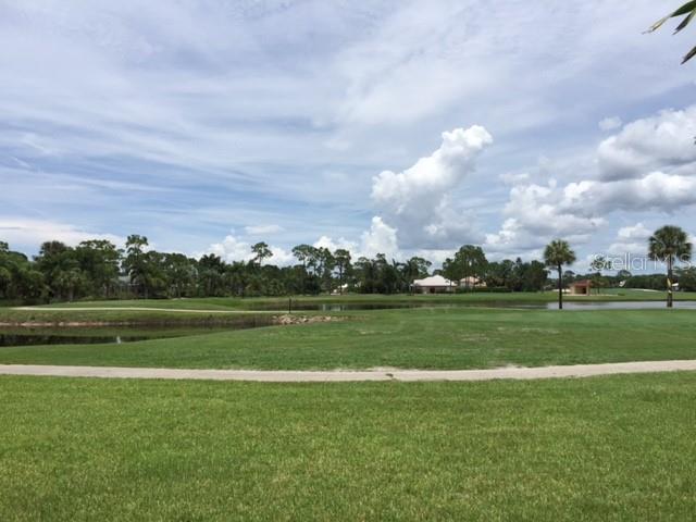 24417 Baltic Avenue, Unit 1102 Punta Gorda, FL 33955 - Photo 51 of 53 a view of a golf course with a lake