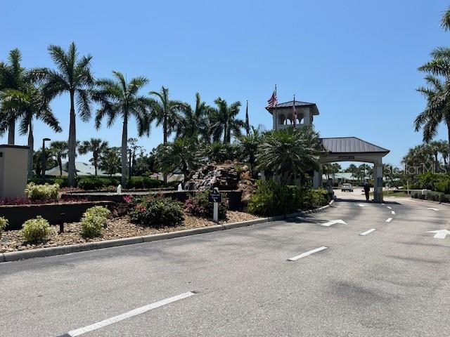 24417 Baltic Avenue, Unit 1102 Punta Gorda, FL 33955 - Photo 52 of 53 a couple of table and a chair in front of a house