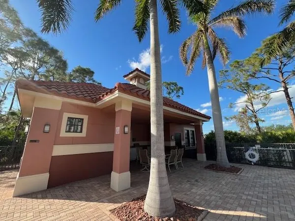 a kitchen with a dining table chairs and white cabinets