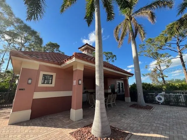 a kitchen with a dining table chairs and white cabinets