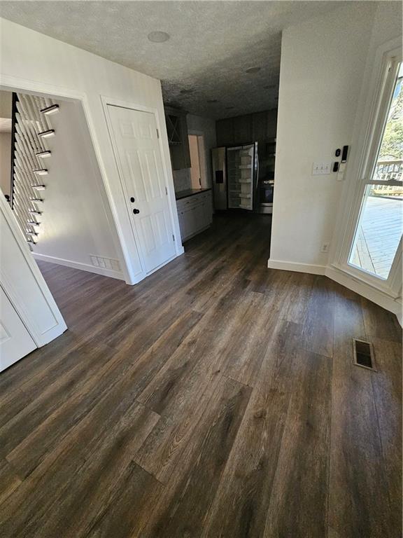 291 Sterling Trail Powder Springs, GA 30127 - Photo 11 of 43 a view of a hallway view with wooden floor and staircase
