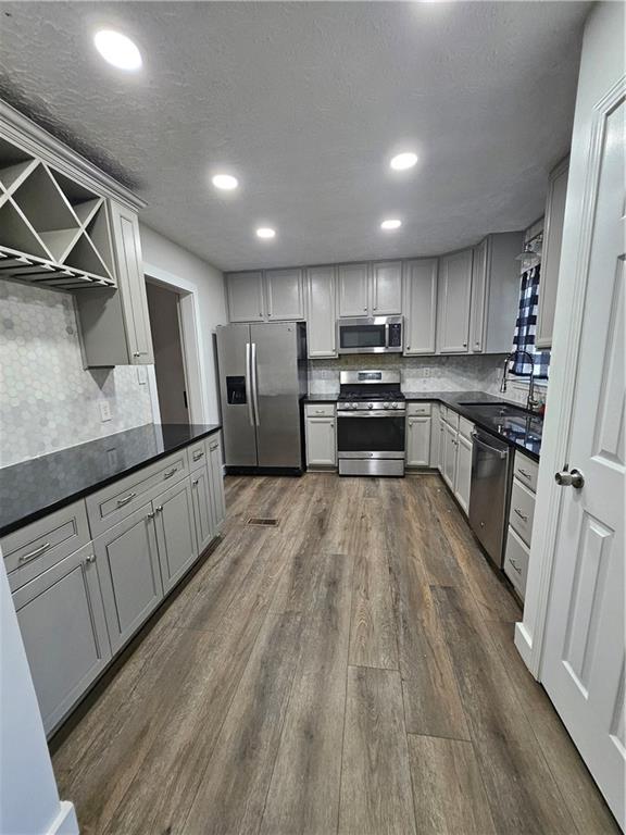 291 Sterling Trail Powder Springs, GA 30127 - Photo 13 of 43 a kitchen with stainless steel appliances sink refrigerator and cabinets