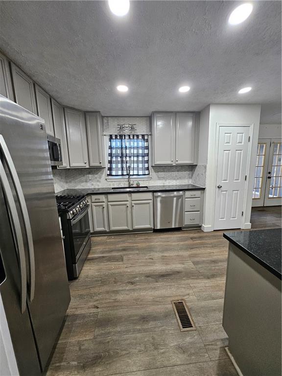 291 Sterling Trail Powder Springs, GA 30127 - Photo 14 of 43 a large kitchen with stainless steel appliances granite countertop a stove a sink and a refrigerator