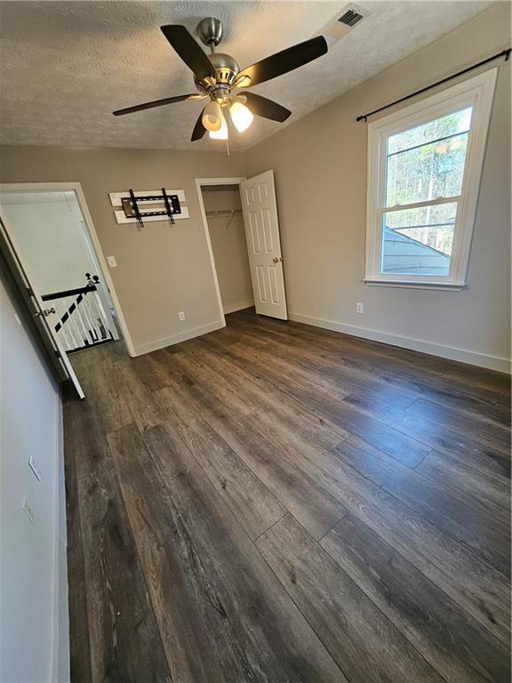 291 Sterling Trail Powder Springs, GA 30127 - Photo 20 of 43 an empty room with wooden floor fan and windows