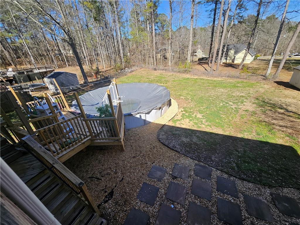 291 Sterling Trail Powder Springs, GA 30127 - Photo 37 of 43 a view of a swimming pool with two chairs and a fire pit