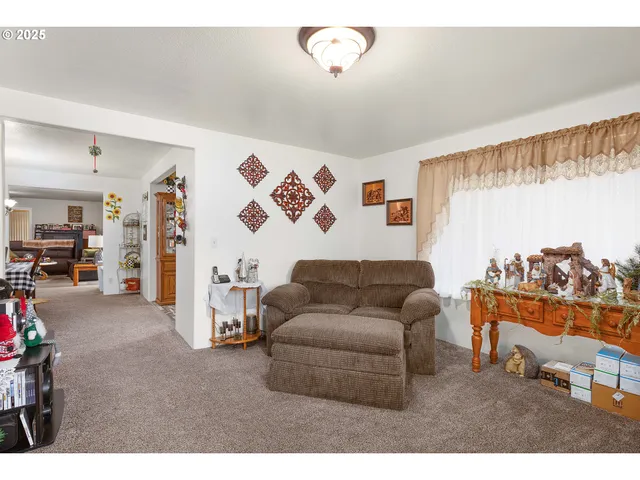a bedroom with furniture a baby crib and a couch