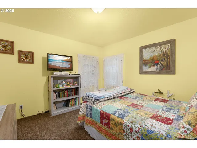 a bedroom with a bed and a view of bedroom