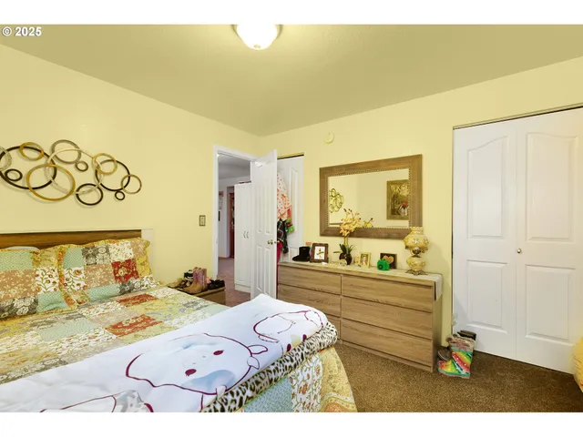 a bedroom with a bed and a book shelf