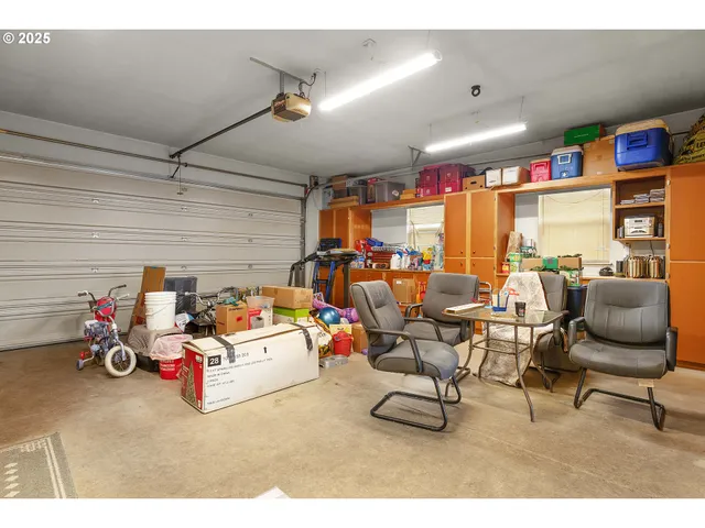 a view of a patio with a dining table and chairs under an umbrella