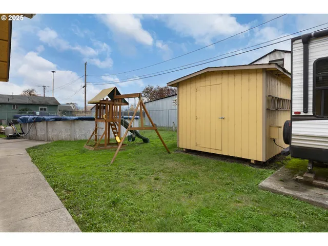 a view of a back yard of the house with a yard