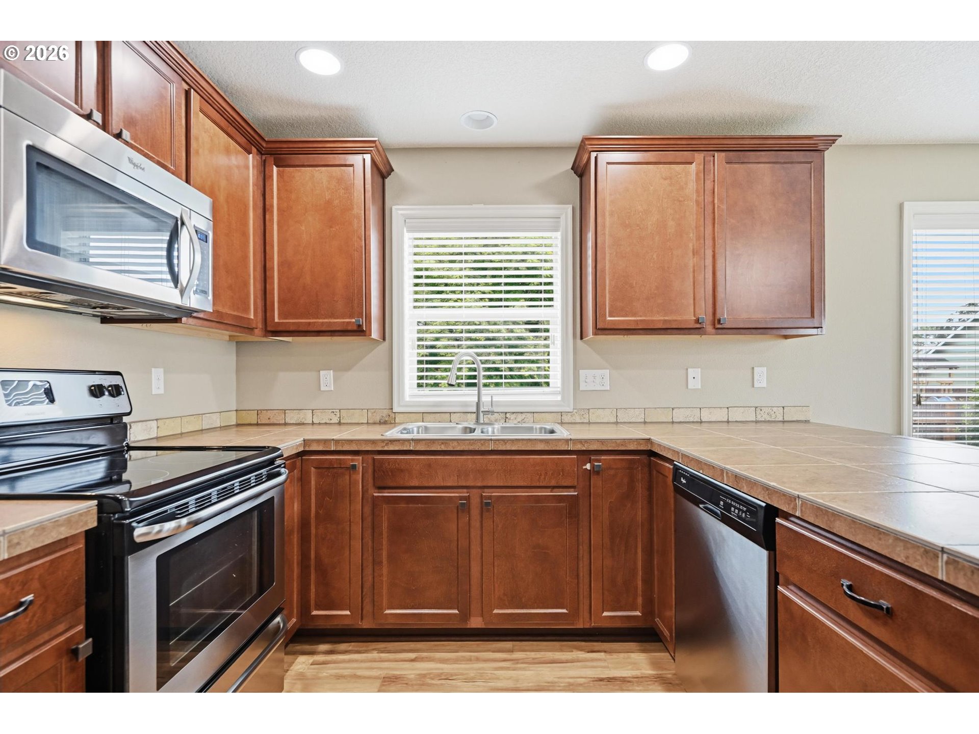 1075 Sage Street Silverton, OR 97381 - Photo 30 of 46 a kitchen with stainless steel appliances granite countertop a sink stove and microwave