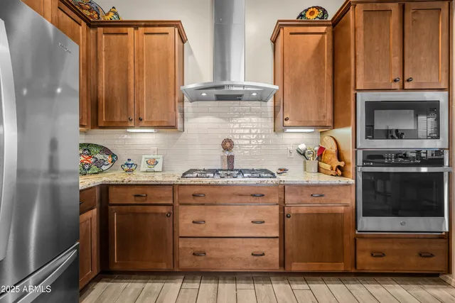 a kitchen with granite countertop a stove a sink and a microwave