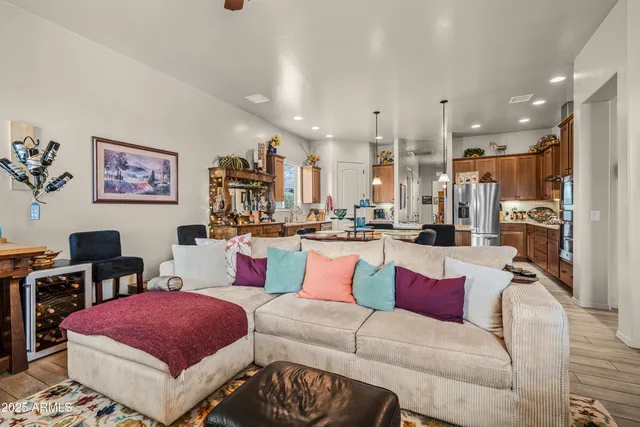 a living room with furniture and kitchen view