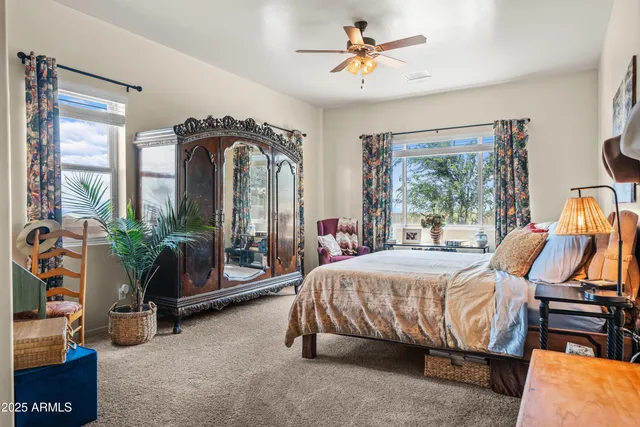 a bedroom with a bed and ceiling fan