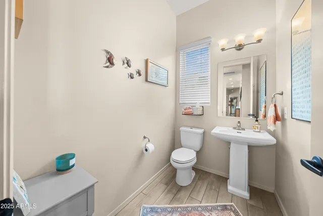 a bathroom with a sink toilet and a mirror