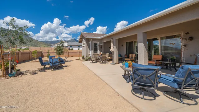 a view of a patio with dining table and chairs