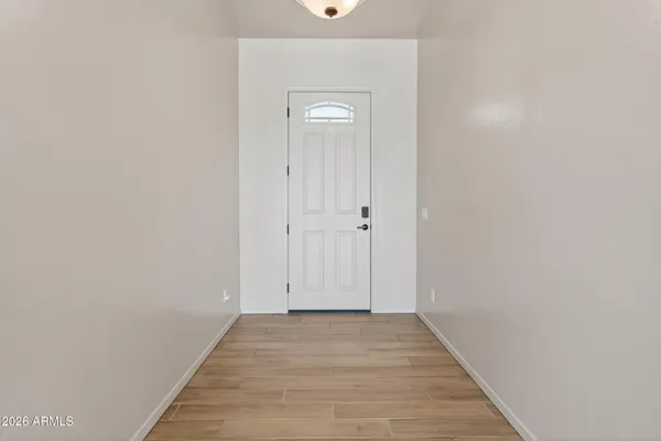 a view of a hallway with wooden floor