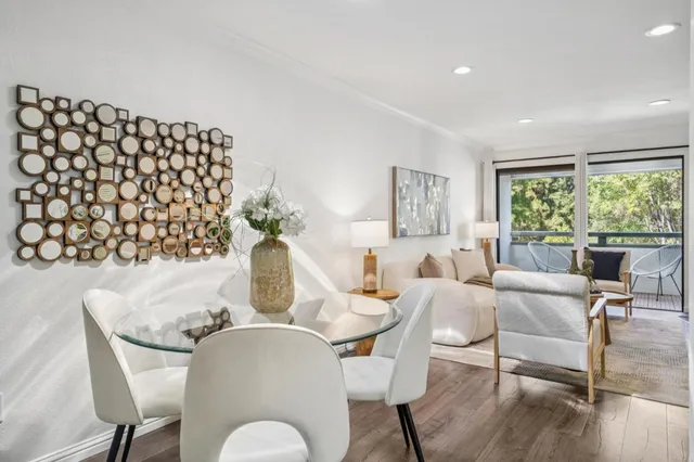 a dining room with furniture a rug and wooden floor