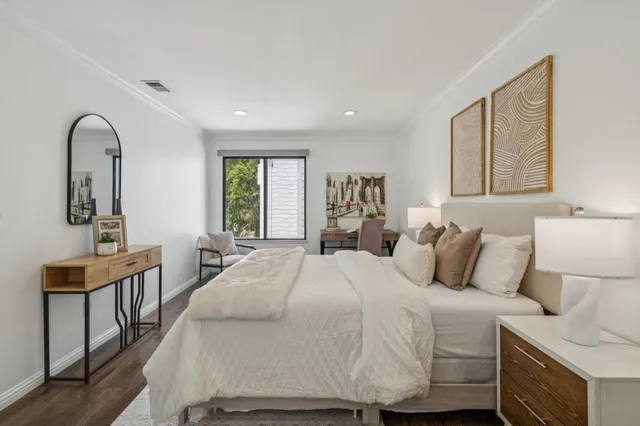 a bedroom with a bed and a table