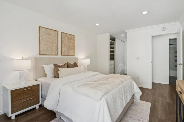 a bedroom with a bed and a night stand