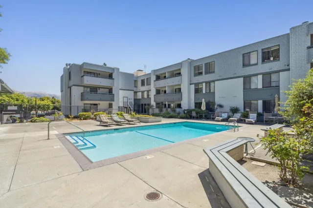 a view of swimming pool with outdoor seating and plants