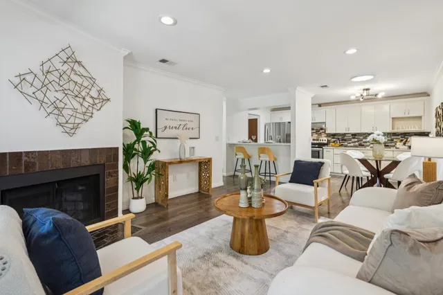 a living room with furniture a fireplace and a table