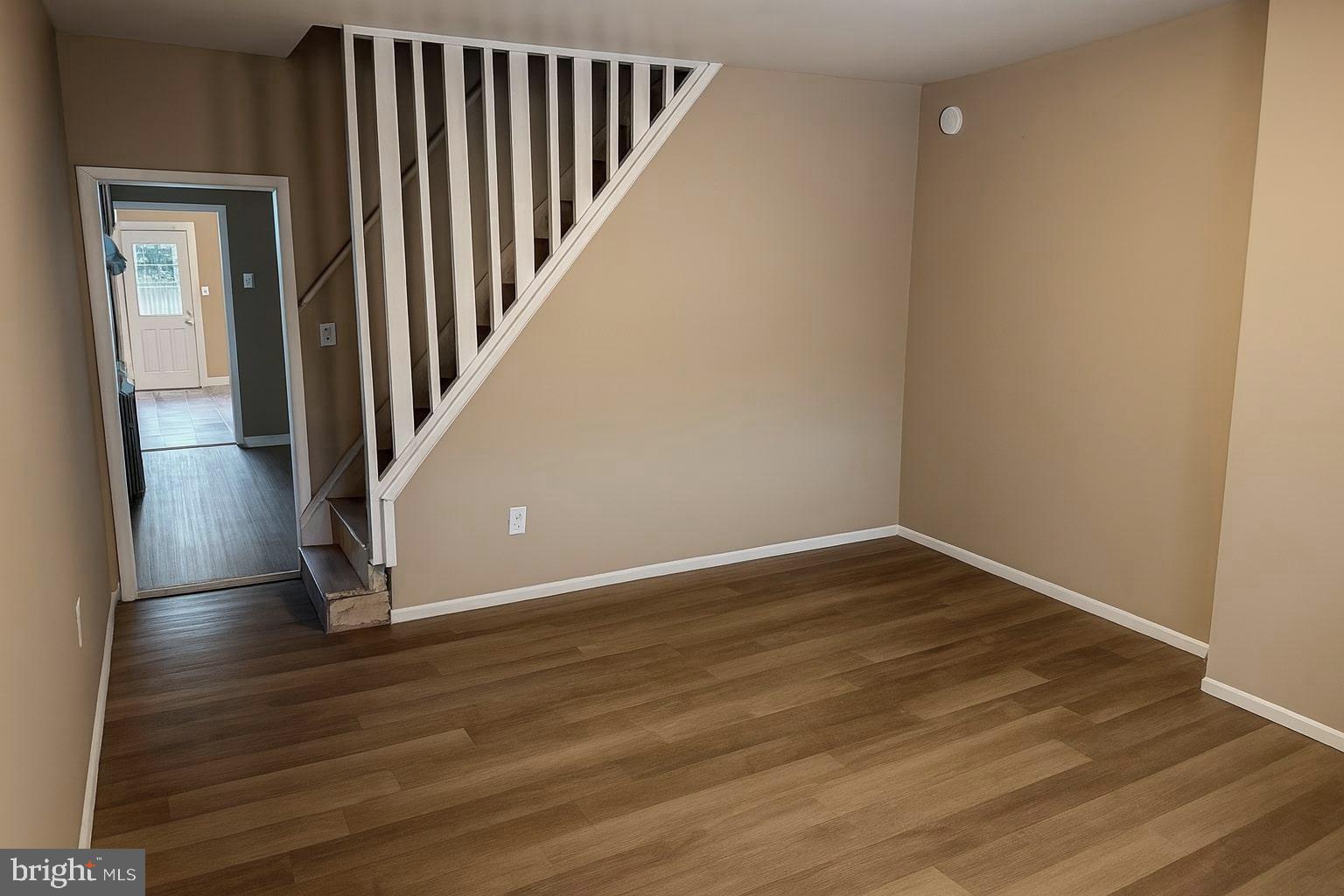 338 Morris Street Gloucester City, NJ 08030 - Photo 2 of 12 a view of an empty room with wooden floor and a hallway