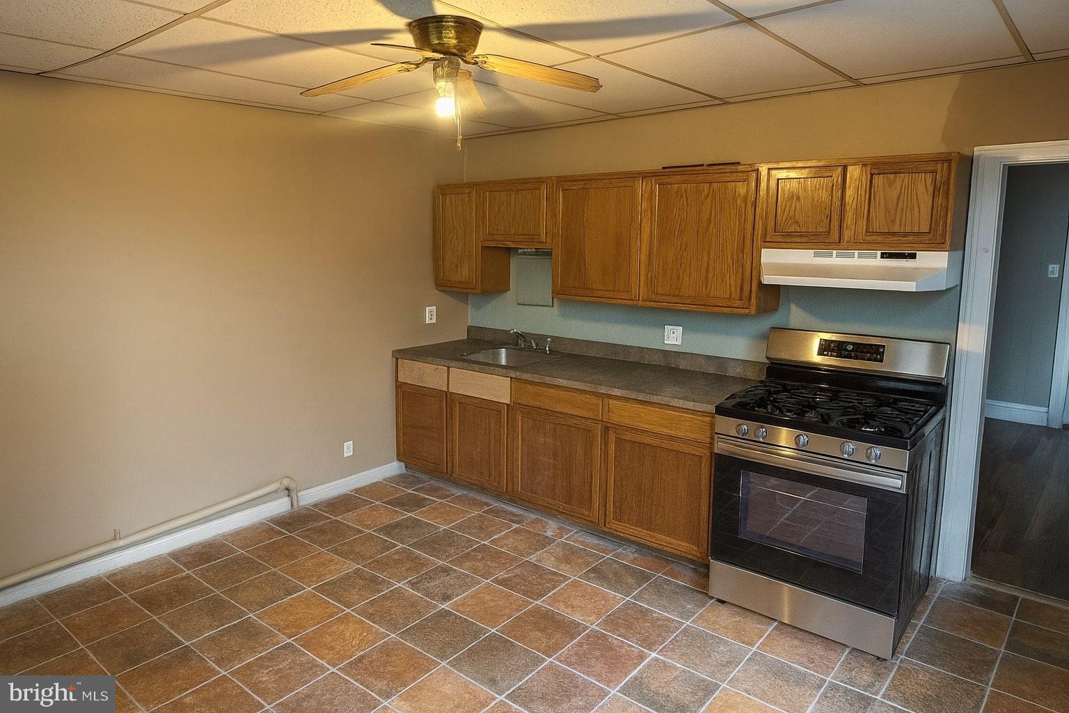 338 Morris Street Gloucester City, NJ 08030 - Photo 3 of 12 a kitchen with granite countertop a sink cabinets and stainless steel appliances