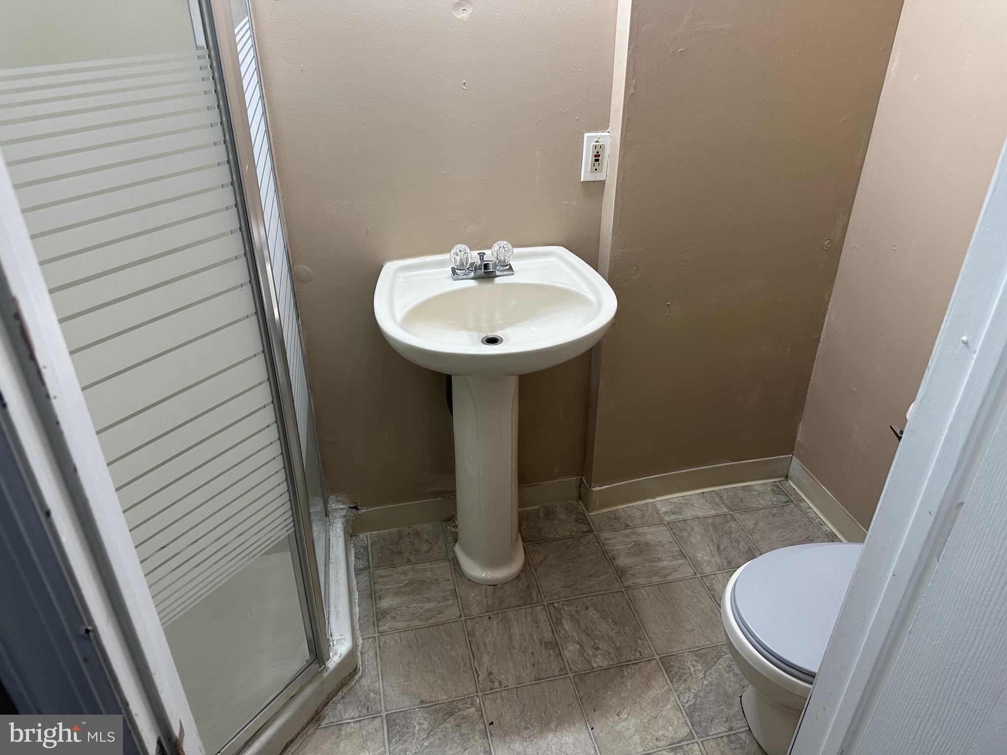 338 Morris Street Gloucester City, NJ 08030 - Photo 4 of 12 a bathroom with a sink and toilet