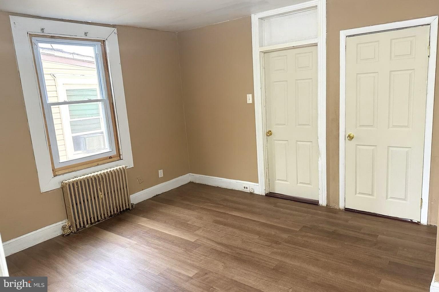 338 Morris Street Gloucester City, NJ 08030 - Photo 5 of 12 an empty room with wooden floor and windows