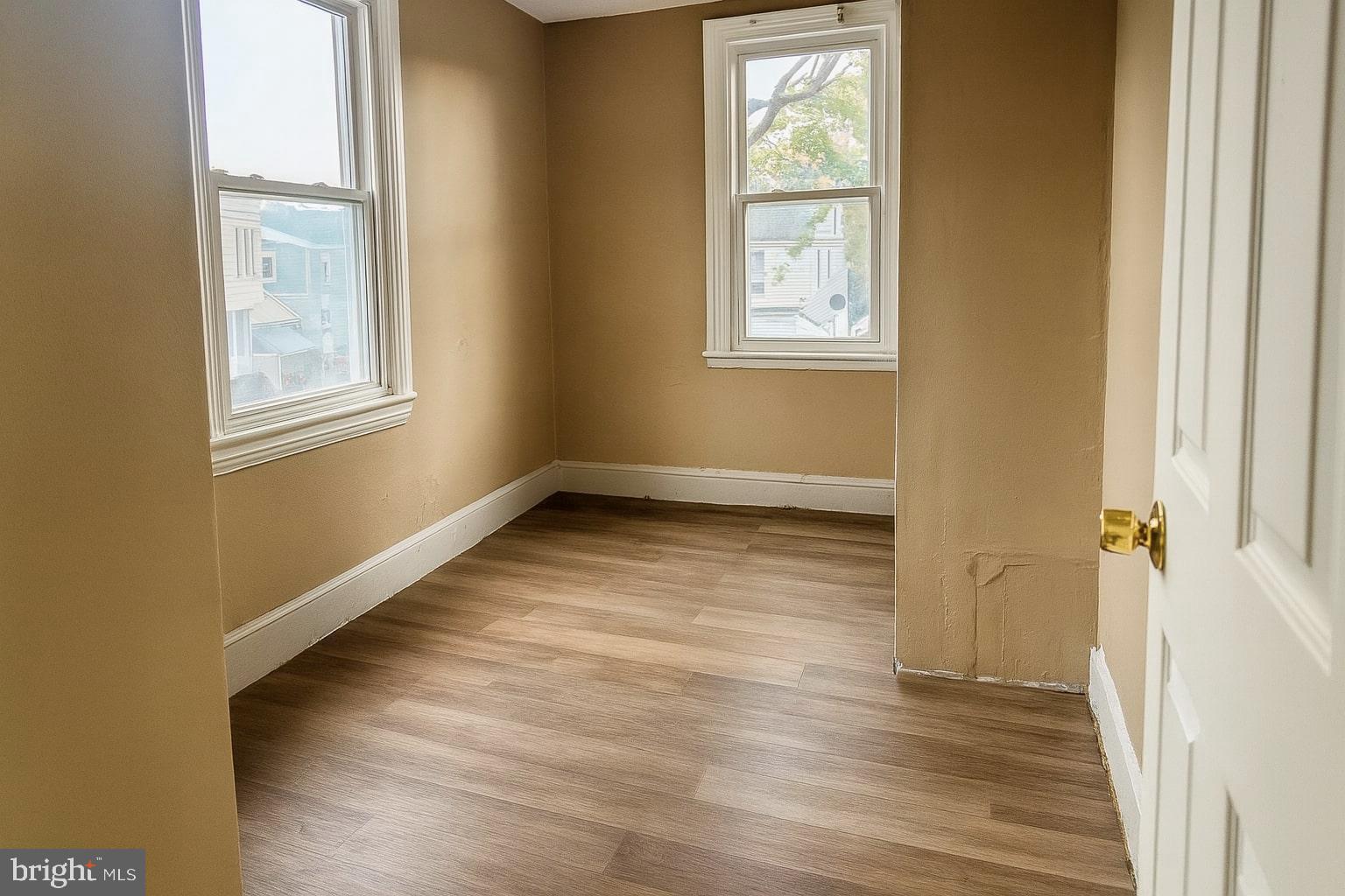 338 Morris Street Gloucester City, NJ 08030 - Photo 6 of 12 a view of an empty room with wooden floor and a window