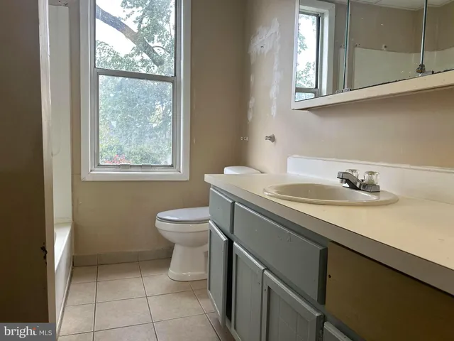 a bathroom with a sink toilet and mirror