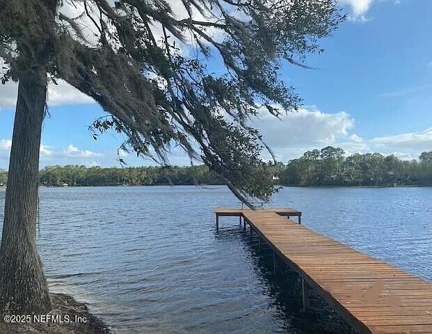 0 Northeast 7th Loop Silver Springs, FL 34488 - Photo 5 of 6 a wooden bench sitting next to a lake