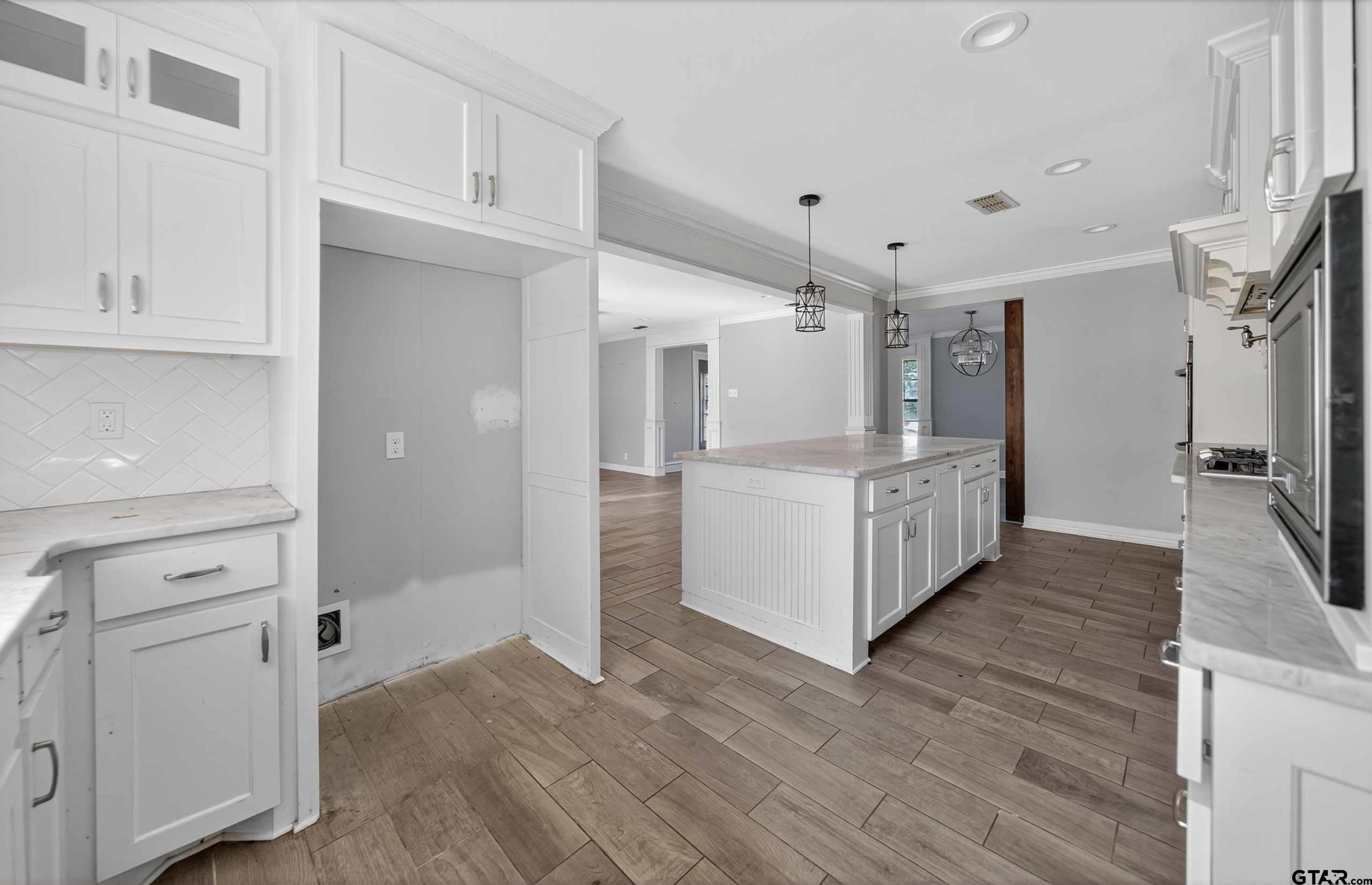 3408 Jackson Avenue Tyler, TX 75705 - Photo 13 of 45 a view of a kitchen with refrigerator and white cabinets