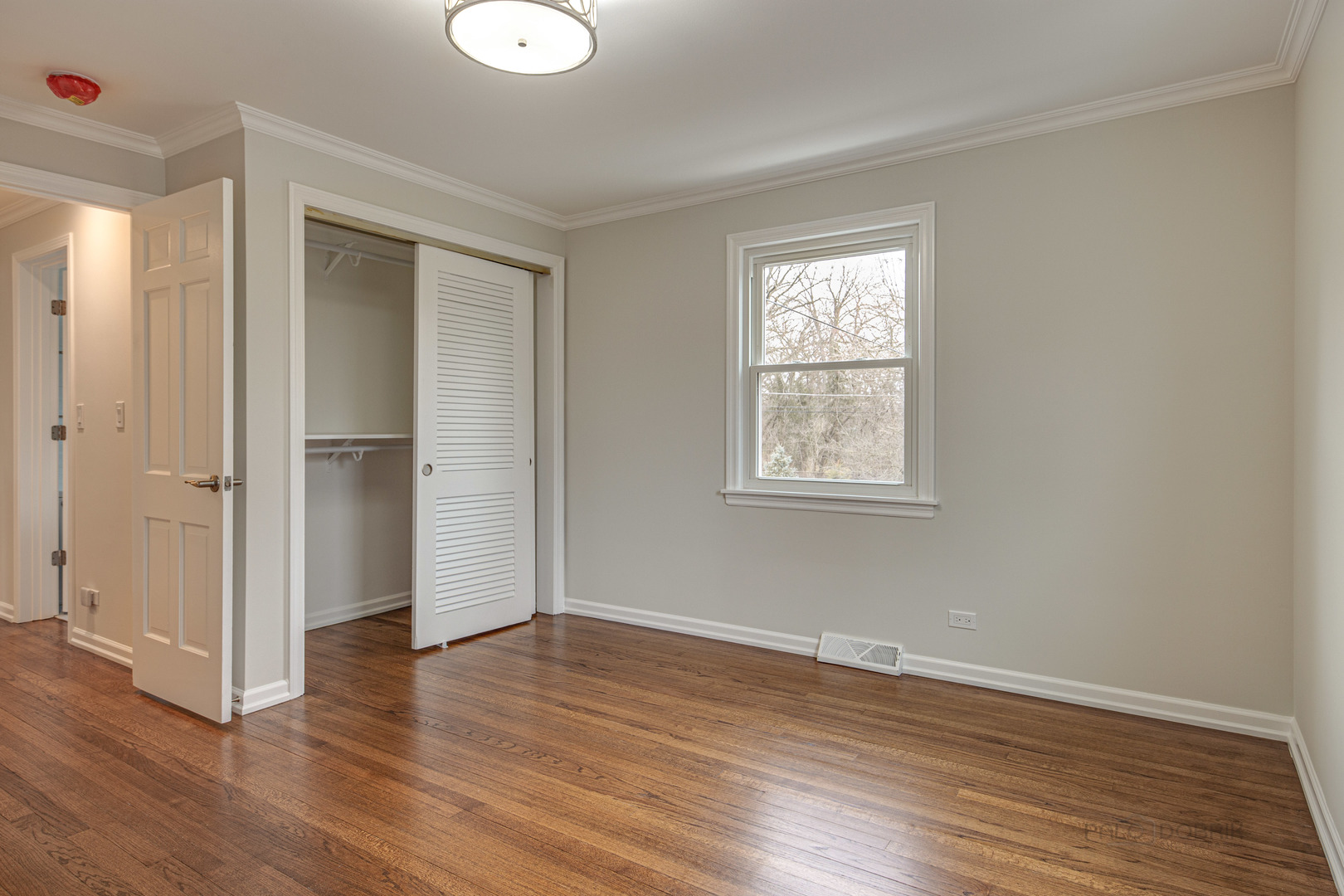 1750 Meadow Lane Bannockburn, IL 60015 - Photo 11 of 19 an empty room with wooden floor and windows