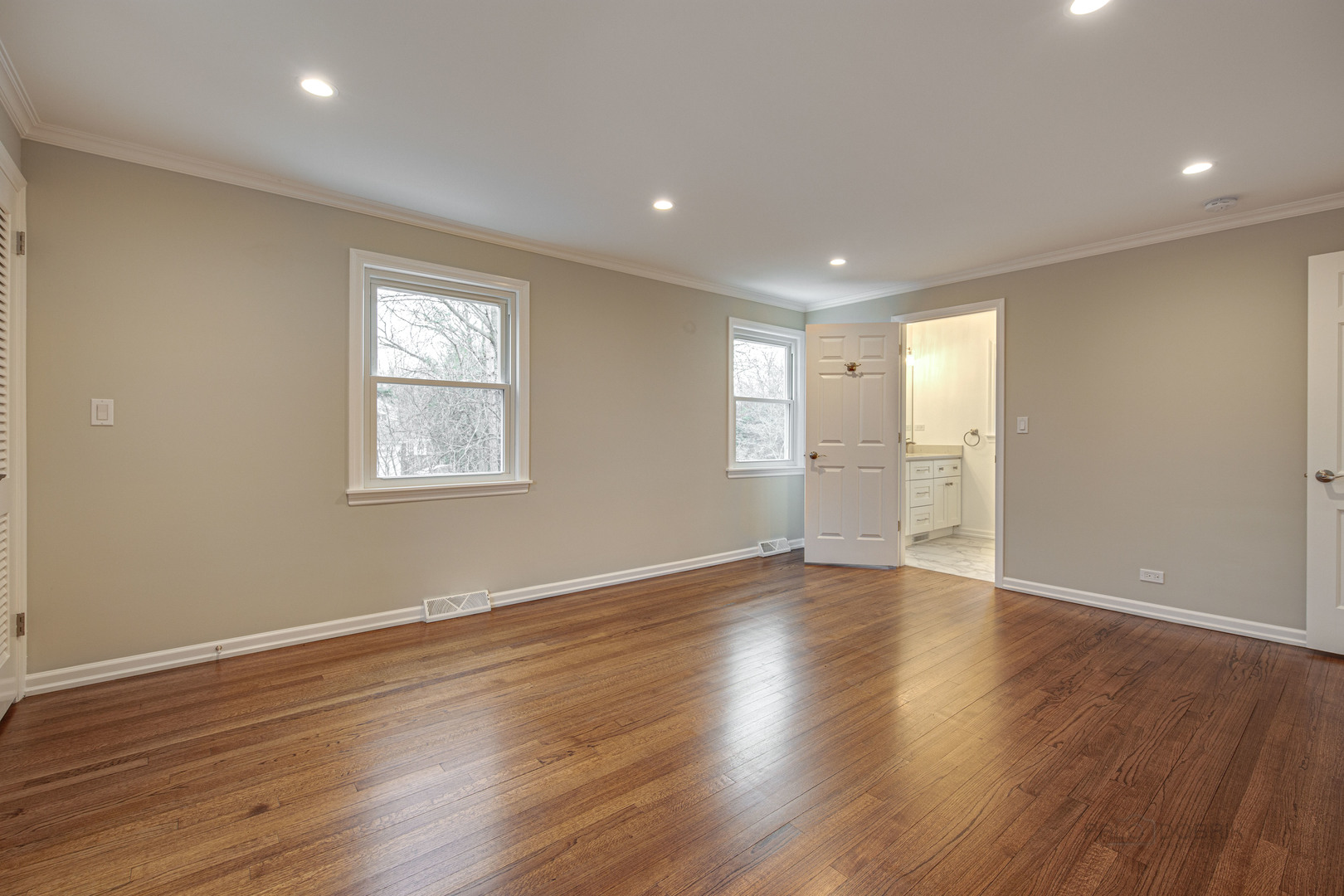 1750 Meadow Lane Bannockburn, IL 60015 - Photo 14 of 19 a view of an empty room with wooden floor and windows
