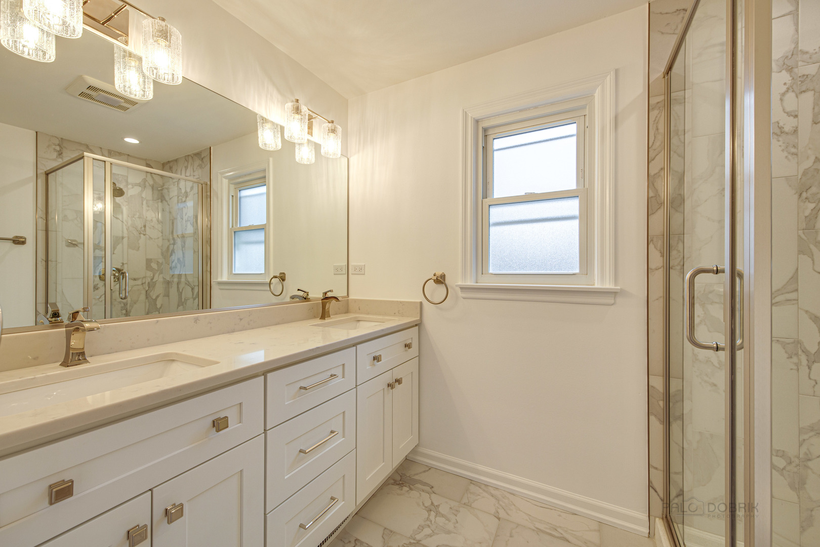 1750 Meadow Lane Bannockburn, IL 60015 - Photo 15 of 19 a bathroom with a double vanity sink and mirror with shower