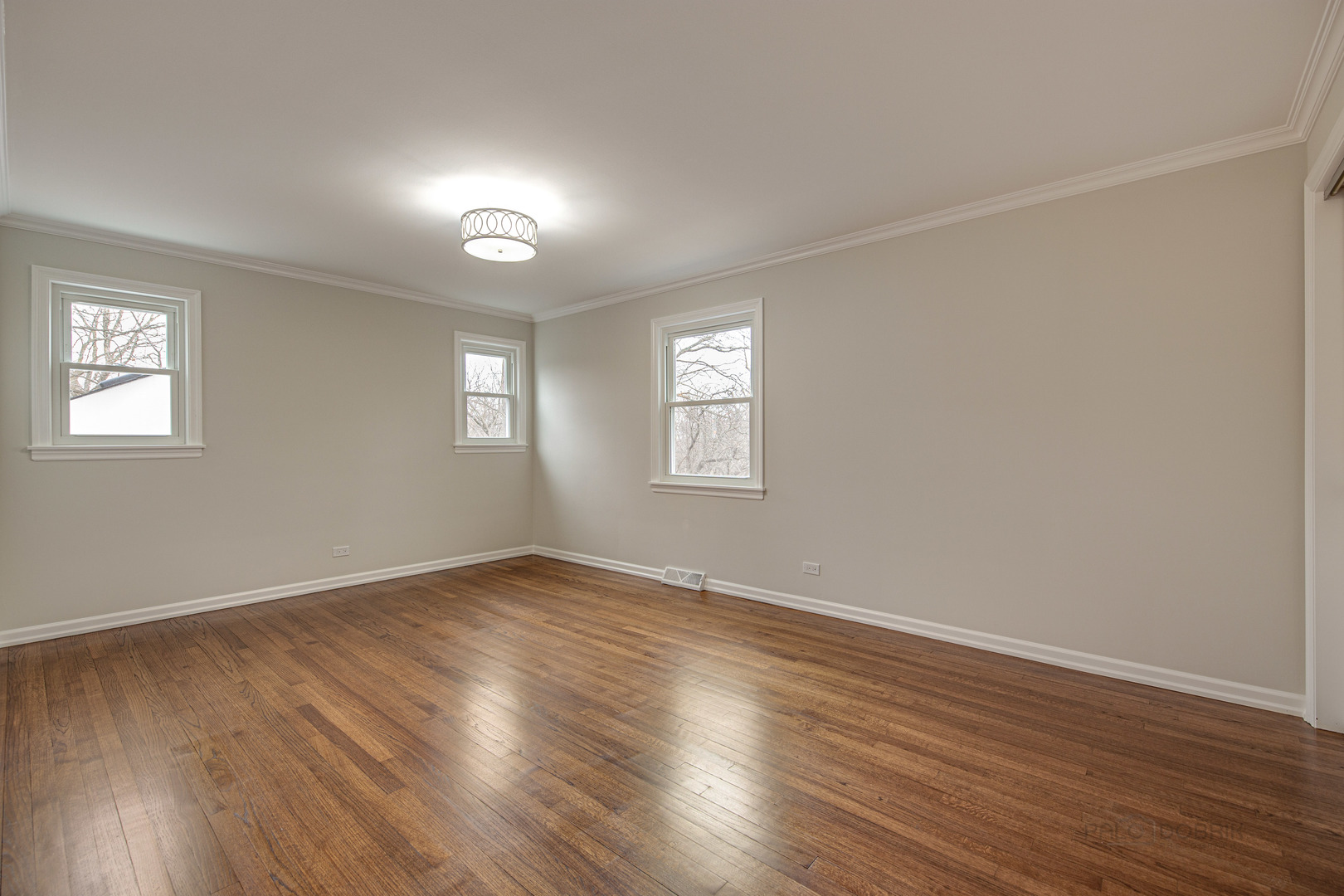 1750 Meadow Lane Bannockburn, IL 60015 - Photo 16 of 19 an empty room with wooden floor and windows