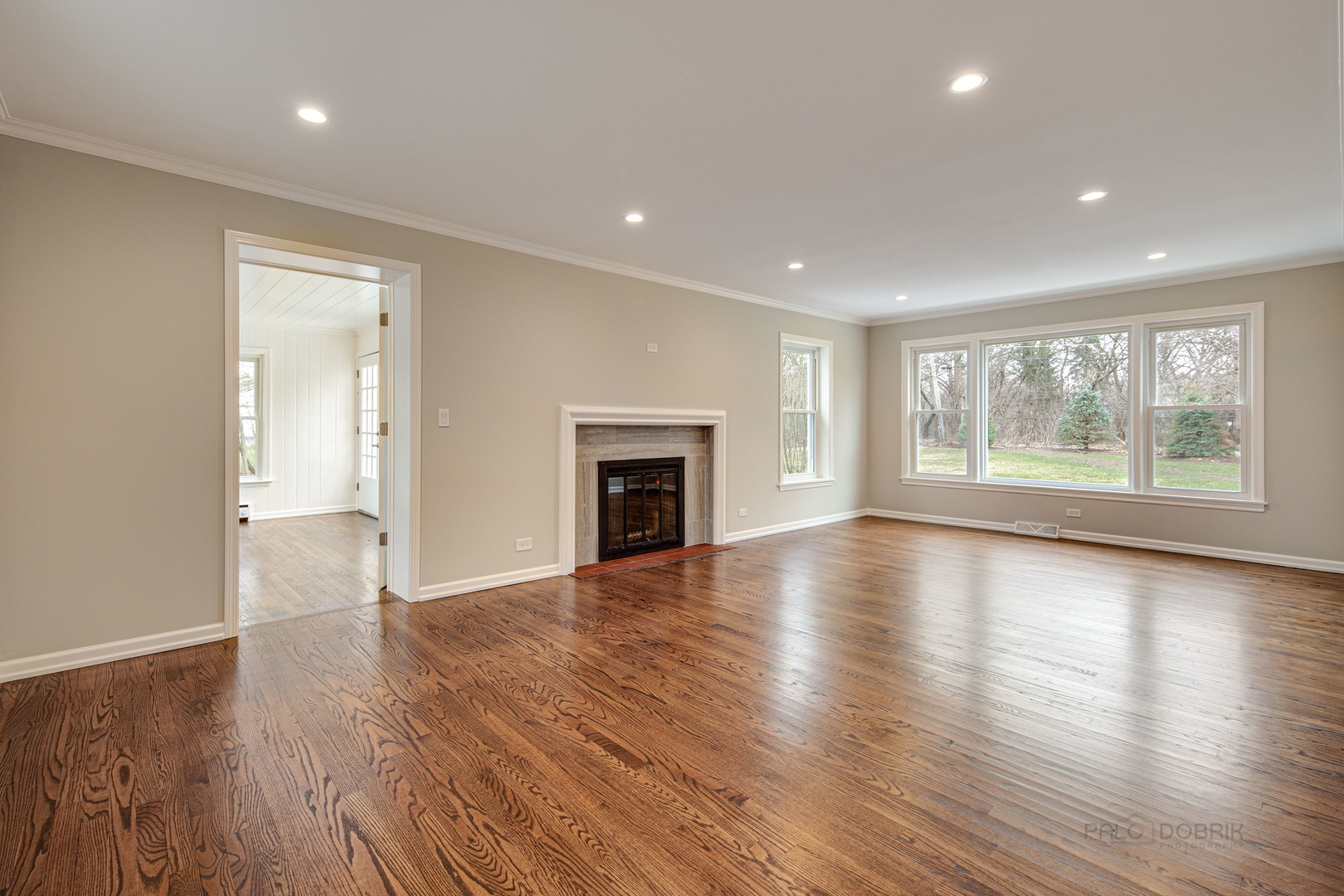1750 Meadow Lane Bannockburn, IL 60015 - Photo 3 of 19 an empty room with wooden floor and a fireplace