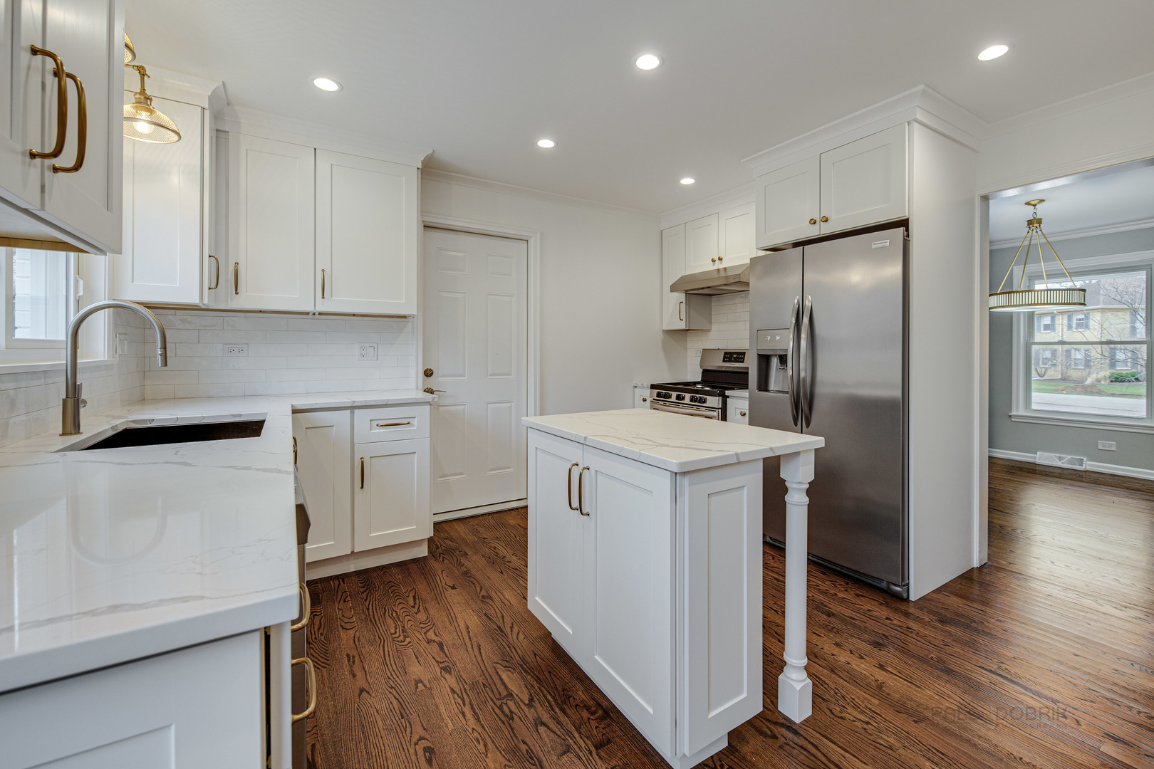 1750 Meadow Lane Bannockburn, IL 60015 - Photo 7 of 19 a kitchen with white cabinets and stainless steel appliances